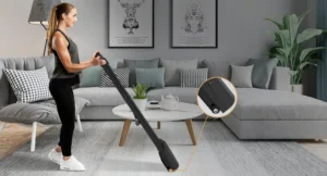 Compact walking pad on a living-room floor beside a sofa (retailer lifestyle image)
