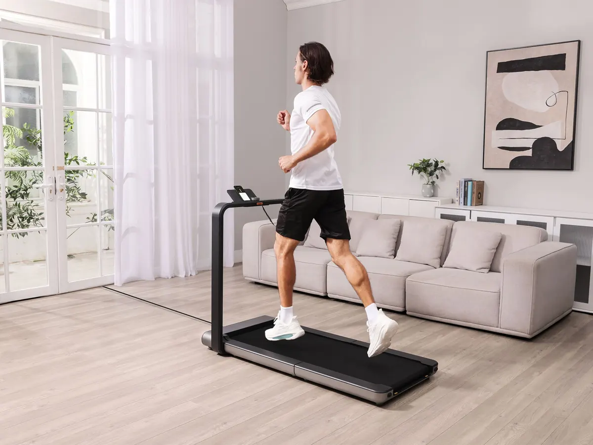 Man jogging on a Kingsmith WalkingPad X21 in a living room (manufacturer image)