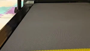 Close-up of the textured black running belt of a walking pad